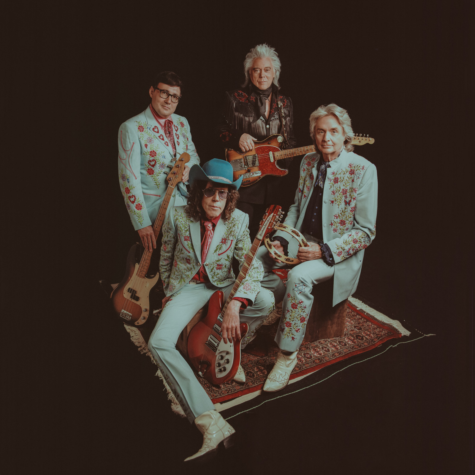 Marty Stuart and His Fabulous Superlatives, all band members seated, holding their instruments.